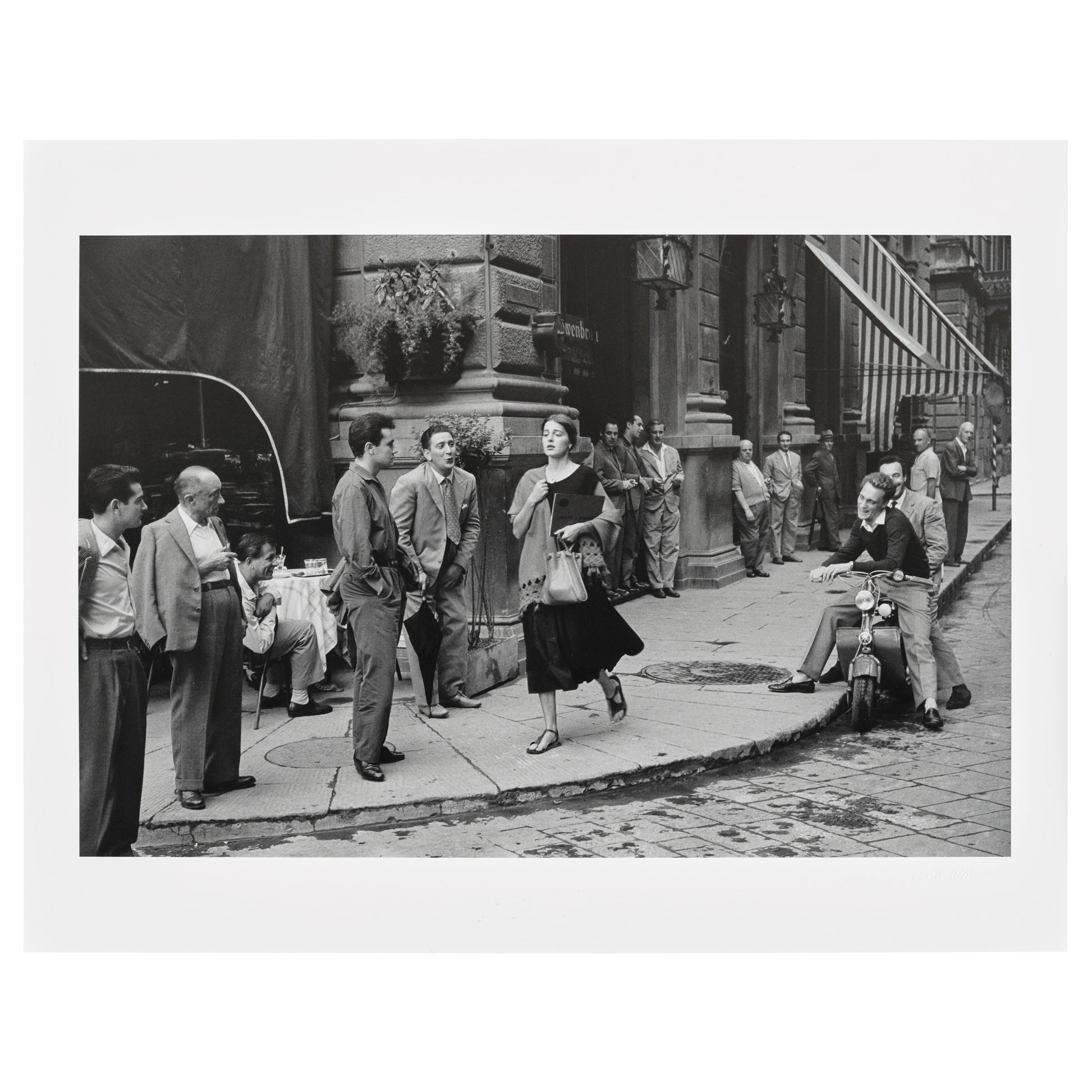 Black and white photo of a street scene with people in an urban setting from American Girl in Italy by Ruth Orkin. 