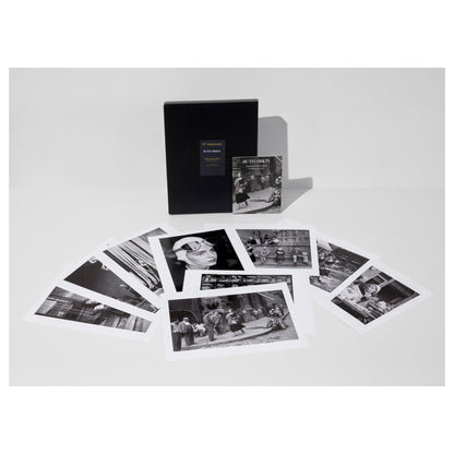 Collection of black and white Ruth Orkin photos from American Girl in Italy, a portfolio box, and an exhibition catalogue on a light gray background