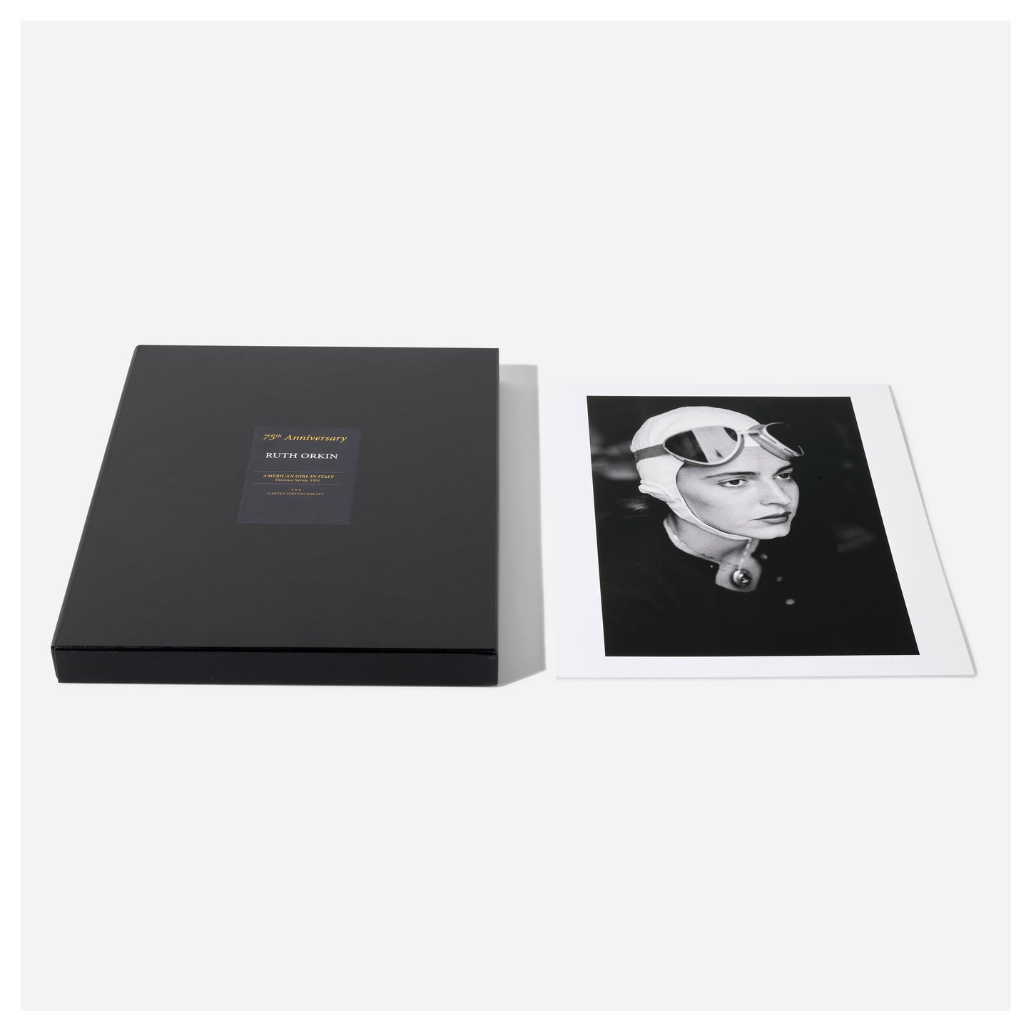 Black portfolio box with a photo of a woman wearing a helmet on a white background from Ruth Orkin's American Girl in Italy.